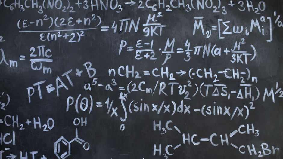 Intricate mathematical and chemical equations chalked on a blackboard symbolizing education and science.