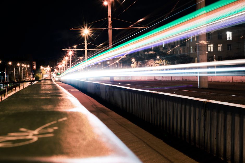 Vibrant long exposure of urban environment capturing colorful light trails at night.