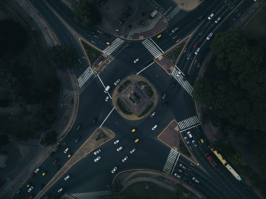 Explore the hustle and bustle of a Buenos Aires roundabout with this striking aerial view, highlighting city traffic dynamics.