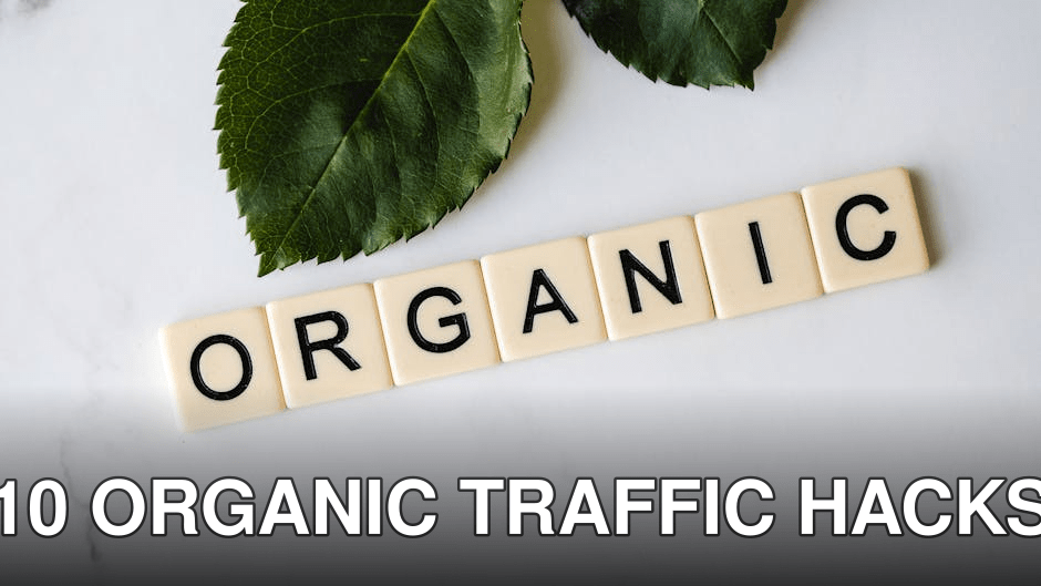 Close-up of 'ORGANIC' spelled with tiles next to a leaf on a marble surface.