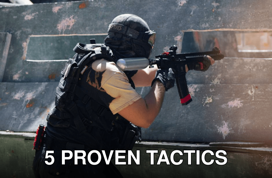 A person engaged in an intense paintball game aiming to hit opponents outdoors.