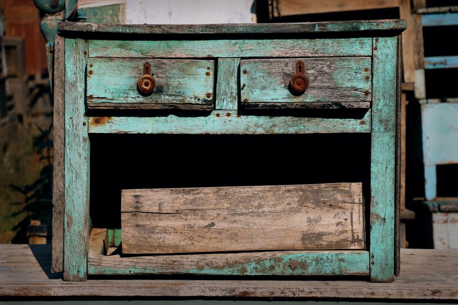 An aged, turquoise wooden drawer with rustic charm, perfect for vintage decor themes.