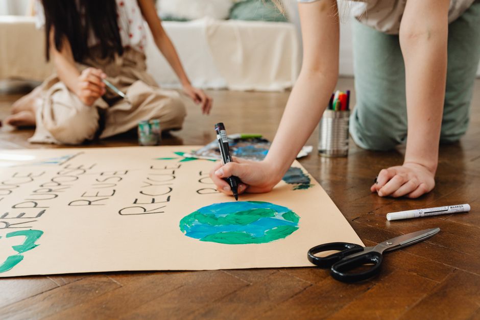 Children involved in an arts and crafts project to promote environmental awareness indoors.