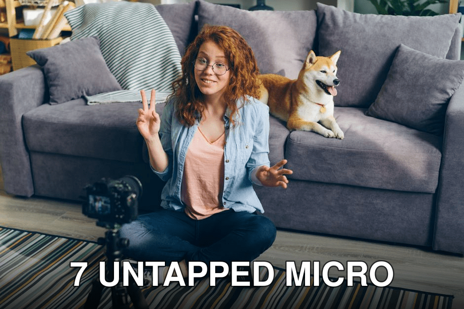 A woman recording a vlog at home while her dog sits on the couch beside her.