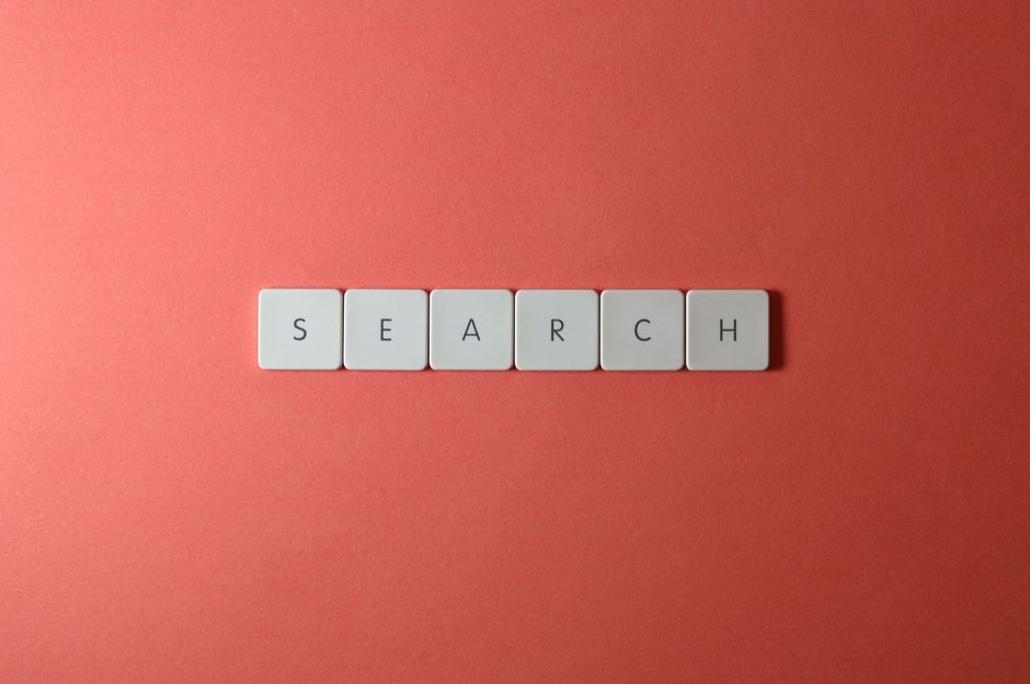 White keyboard keys spelling 'search' on a bold red surface, conceptual design with copyspace.