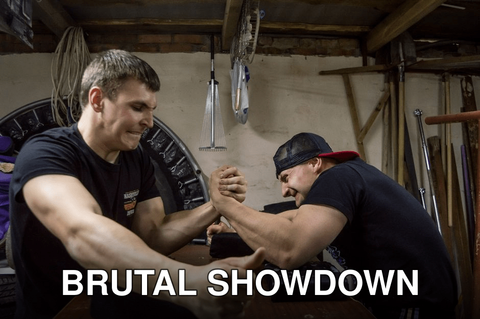 Two muscular men engaging in competitive arm wrestling in a rustic gym environment.