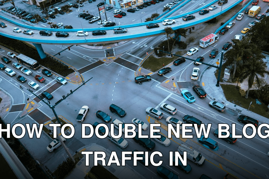Aerial view of a busy urban intersection filled with cars and traffic under a blue overpass.