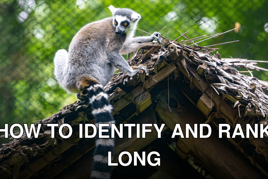 Ring-tailed lemur perched on a straw roof with a lush green backdrop.