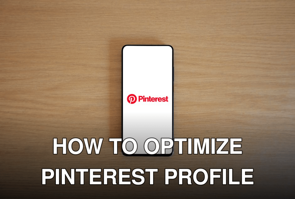 Smartphone with Pinterest logo on screen placed on a wooden surface, minimalistic tech concept.