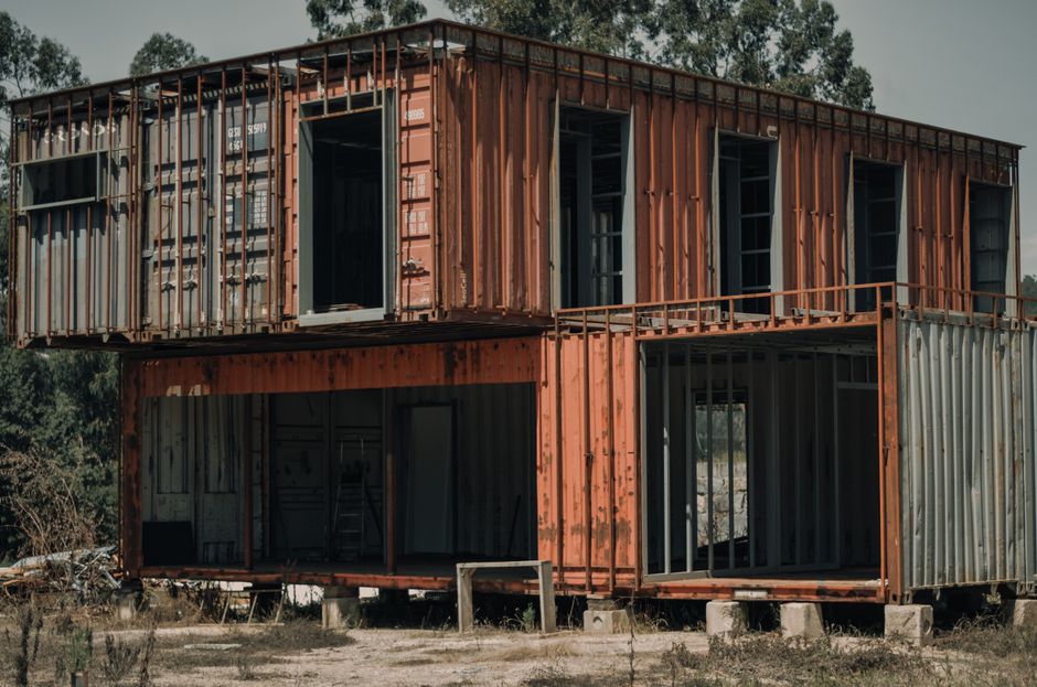 An old, repurposed shipping container building located in a rural area near Paços de Ferreira, Portugal.