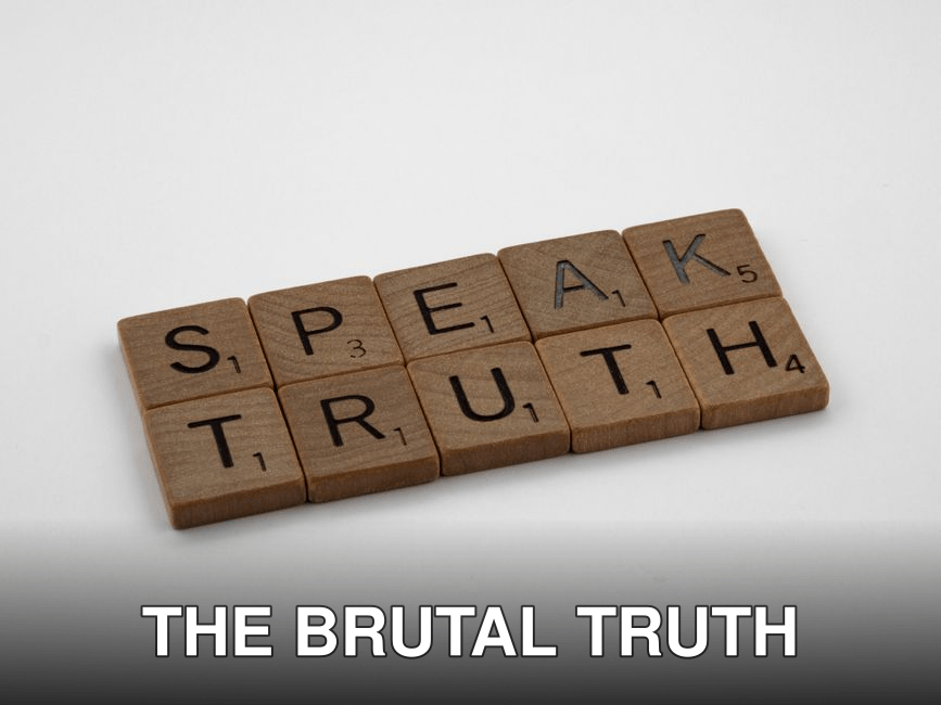 Wooden Scrabble tiles forming the words 'Speak Truth' on a white background.