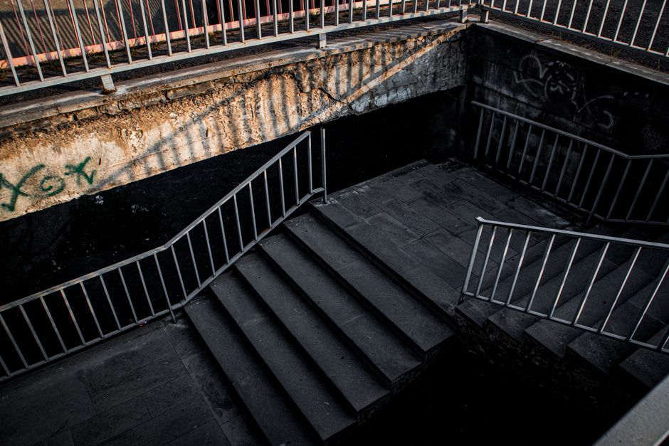 Brutalist urban stairs in Yerevan with dramatic lighting and gritty atmosphere.