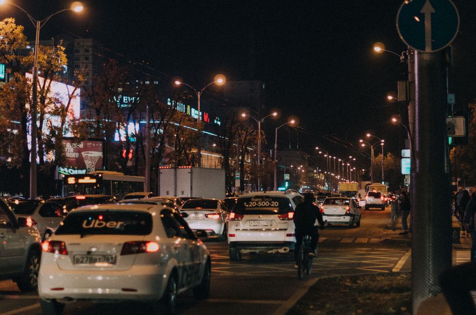 Busy nighttime scene of urban life and traffic in Krasnodar, Russia city center.