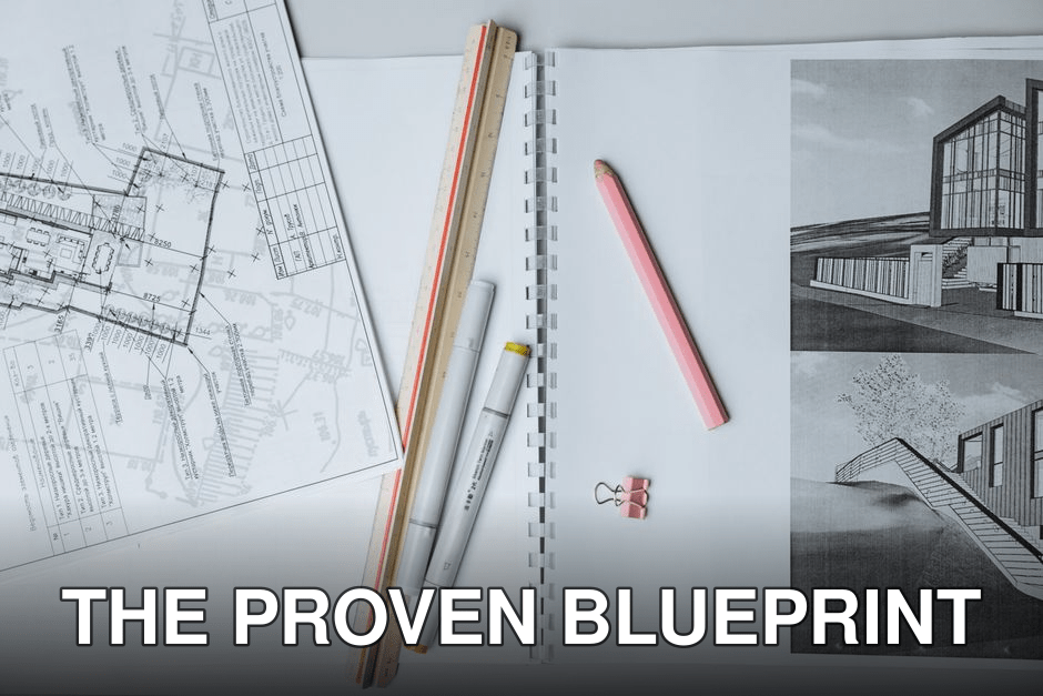 Flat lay of architectural blueprints, drawing tools, and stationery on a desk surface.