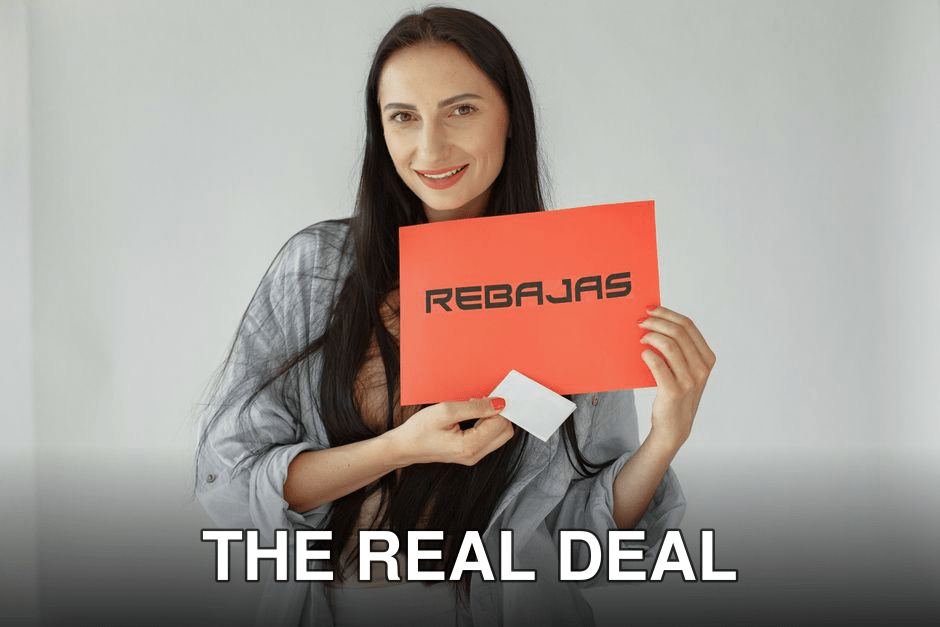 Smiling woman holds a red 'REBajas' sign, promoting sales and discounts.