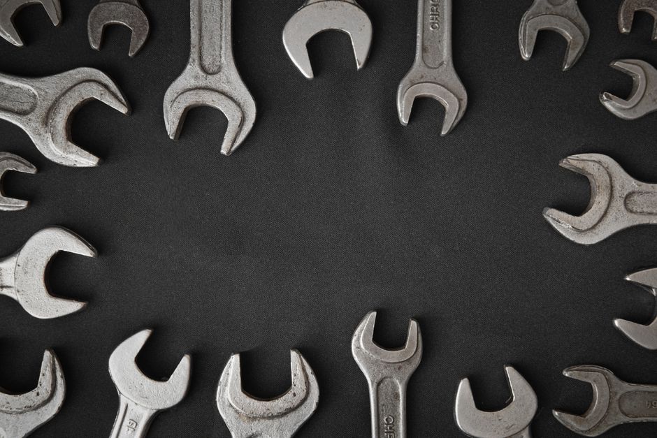 Assorted spanners laid out in a circular pattern with copy space.