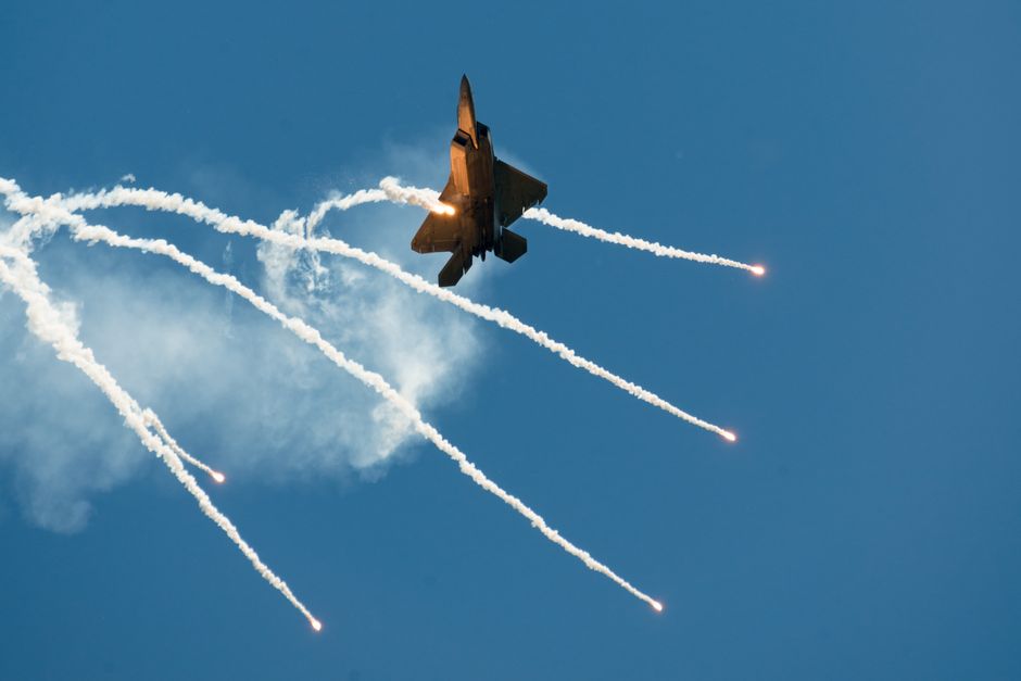 Dramatic view of a fighter jet releasing flares during an air show in Fairfield, California.