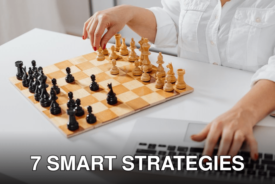 Close-up of a person playing chess and using a laptop indoors.