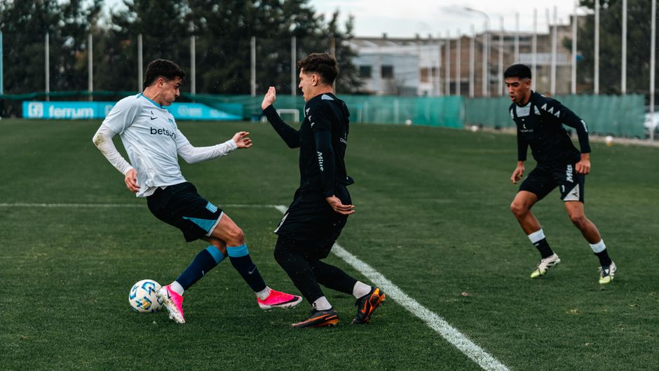 High-energy soccer training with young athletes practicing on a field outdoors.